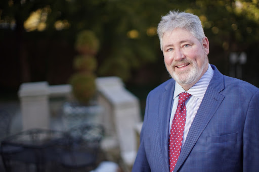 Dr Kevin Quinn smiling in a suit