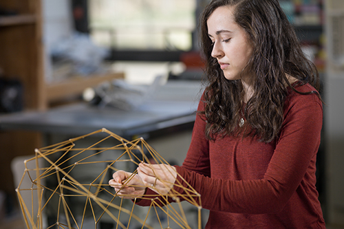 student working on art project