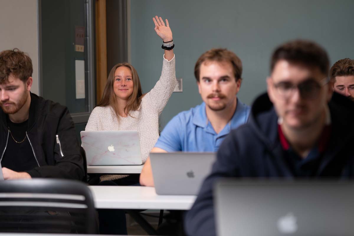 Student raising hand in class