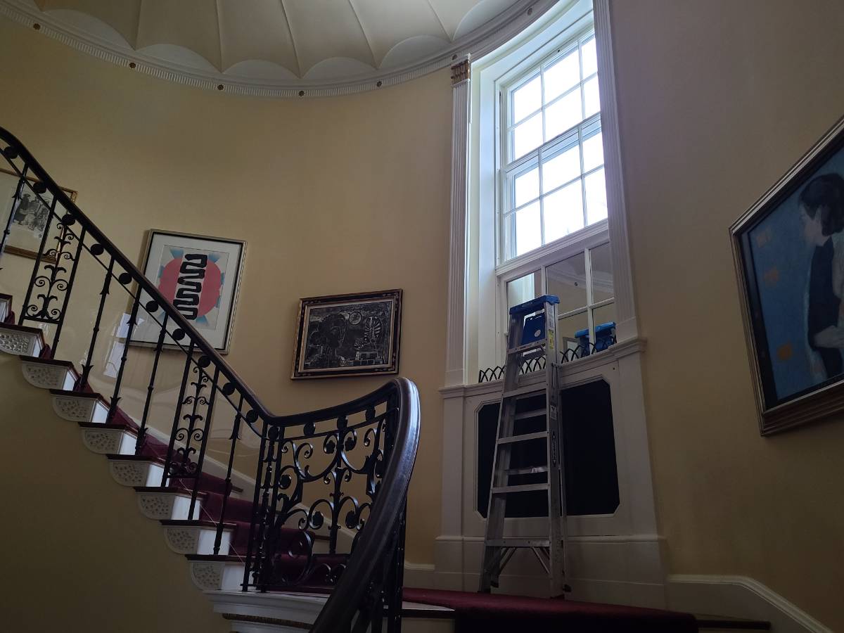 Brookby staircase with the high front facing window. A ladder is placed beside to show the height of the window.