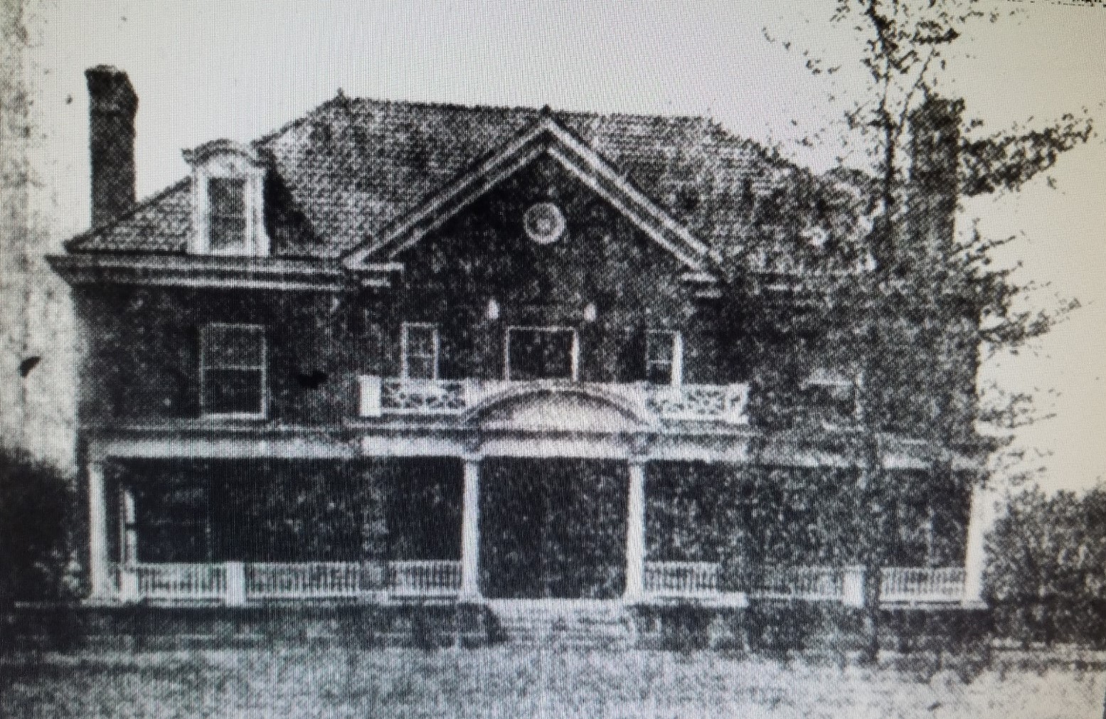 An old photo of Browne Center in black and white. Three stories with a wide porch.