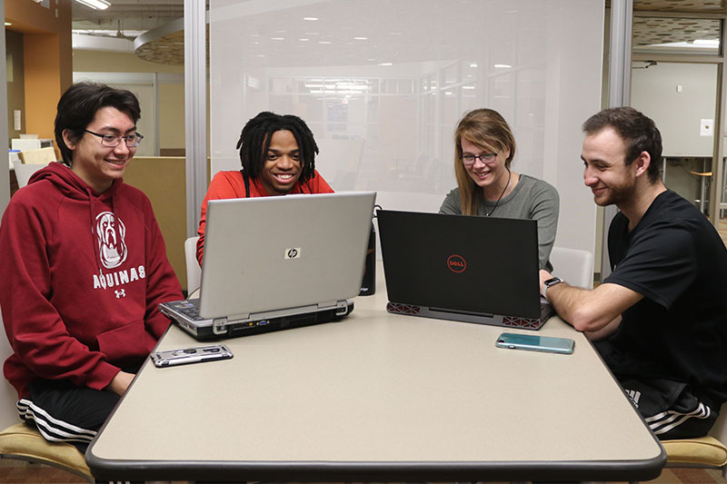 Four CIS students working on a project