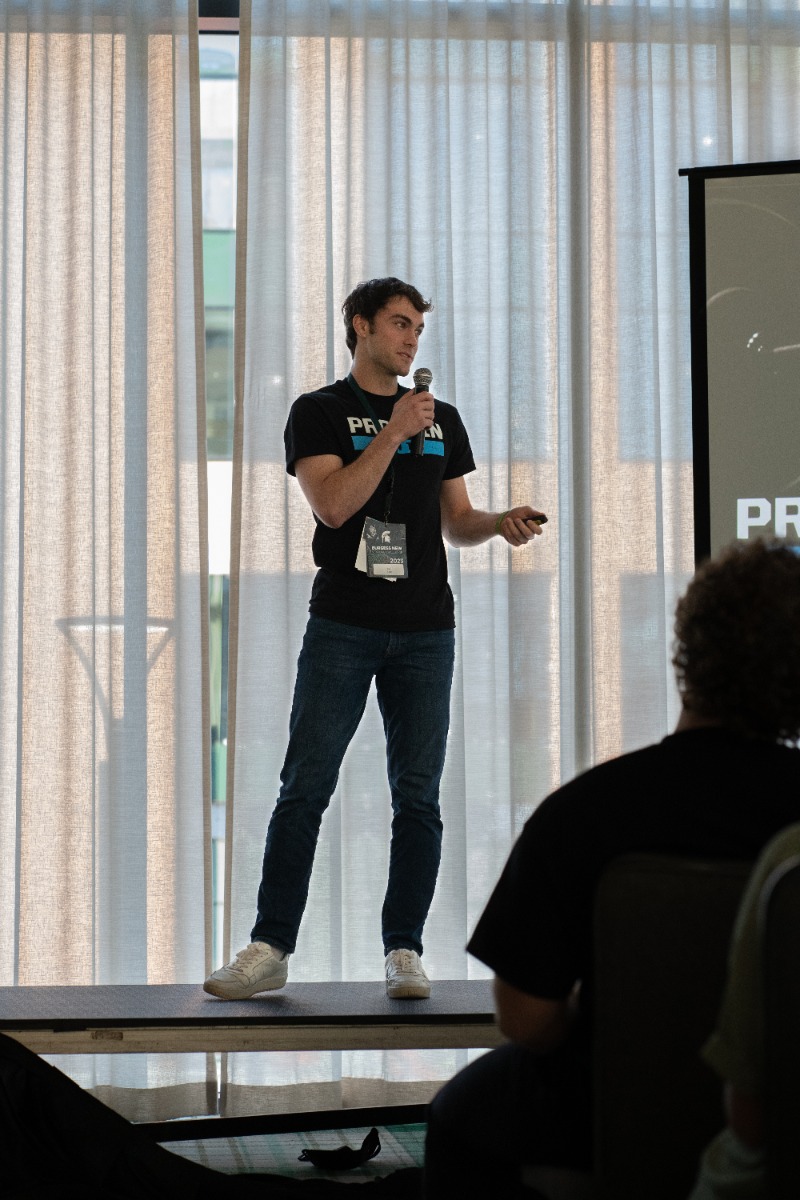 Paul Reiss pitching his product on a stage wearing a Protein Pints t shirt