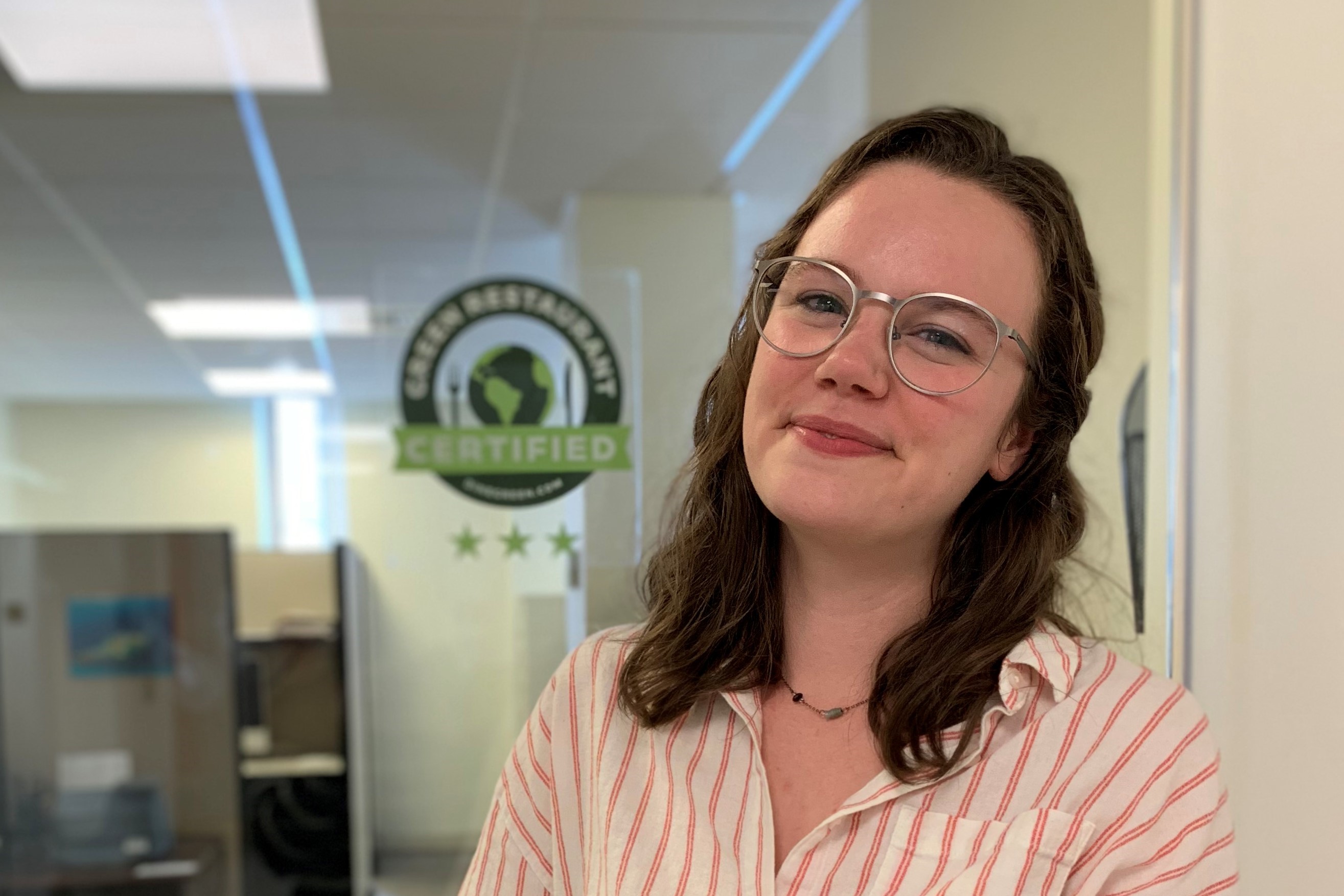 Alum smiling in an office