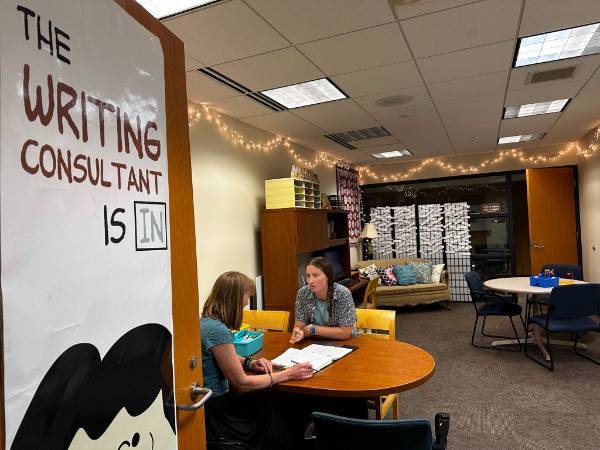 Image of the interior of the Writing Center with two women consulting inside.