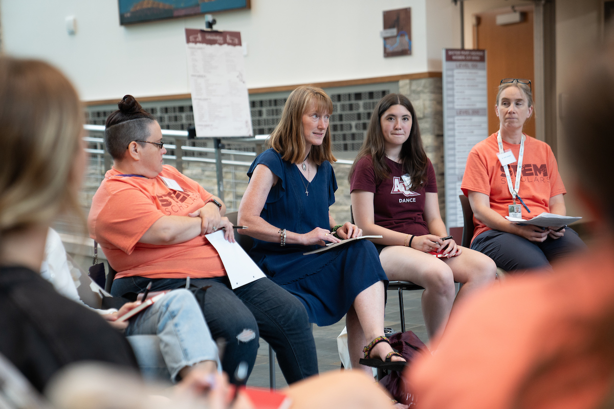 Writing Center Director Julie Bevins speaks with students