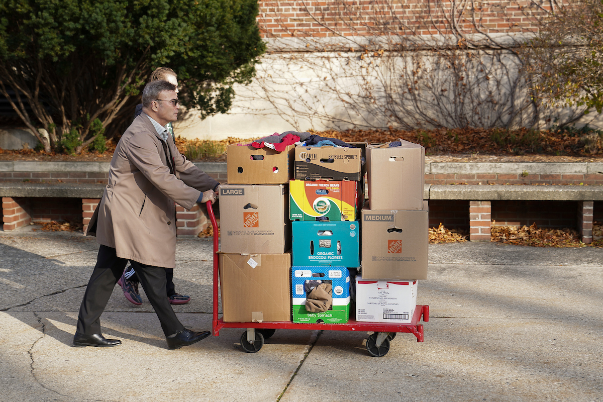 Professor Mark O'Toole pushes a cart full of donations