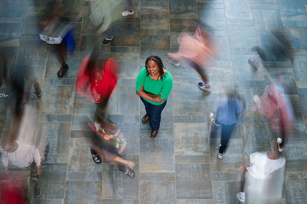 Dr. Keli Christopher pictured from above with blurred students running around her