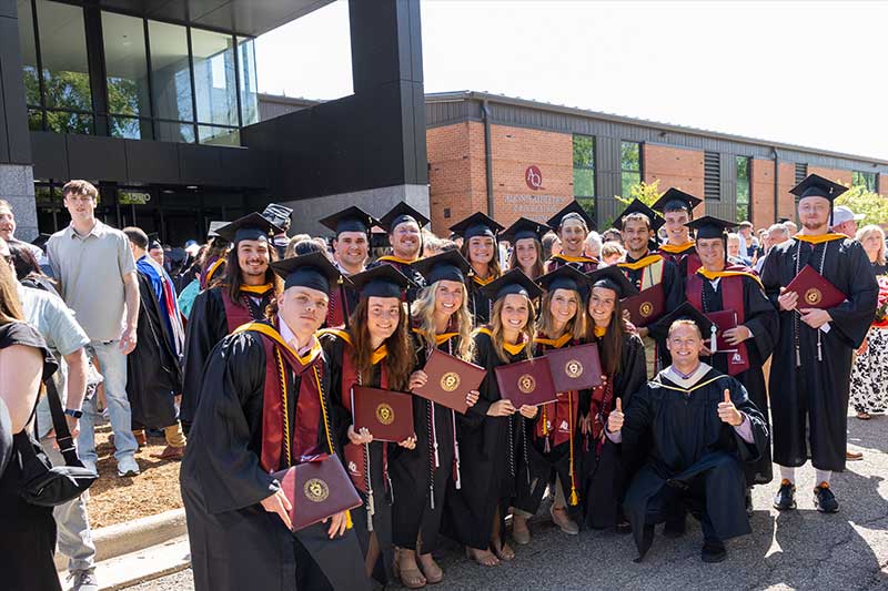 Graduates outside Sturrus Sports & Fitness Center