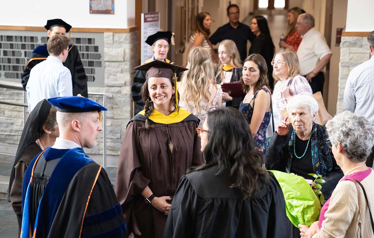 Students, families, and faculty gather at academic reception in Albertus Magnus atrium at Aquinas College