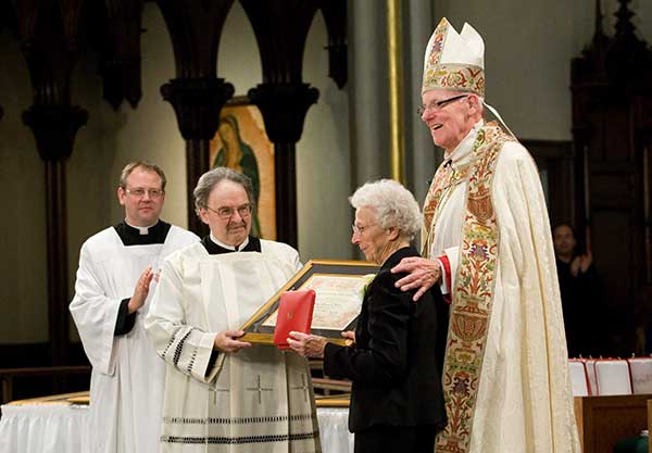 In 2012, Sister Aquinas was awarded the papal cross, Pro Ecclesia et Pontifice, by Pope Benedict XVI. The award was bestowed by Grand Rapids Bishop Walter A. Hurley, assisted by, from left, Fathers Anthony Pelak and Thomas Tavella, CSP.