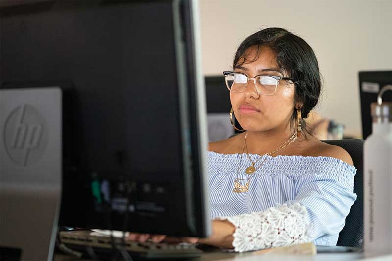 Aquinas student working on a computer